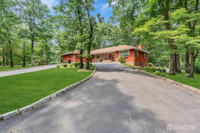 2 Crommelin Ct, East Brunswick, NJ 08816 - ranch-style home with curved driveway, a chimney, and a front lawn