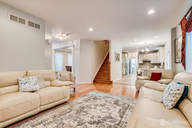 35 Fabiszewski Way, Parlin, NJ 08859 - living area featuring a chandelier, stairs, recessed lighting, light wood-style flooring, and baseboards
