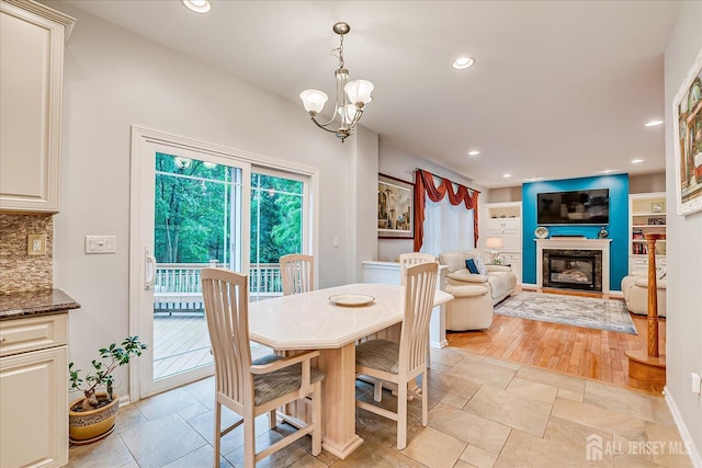 35 Fabiszewski Way, Parlin, NJ 08859 - dining space with recessed lighting, a chandelier, and a glass covered fireplace