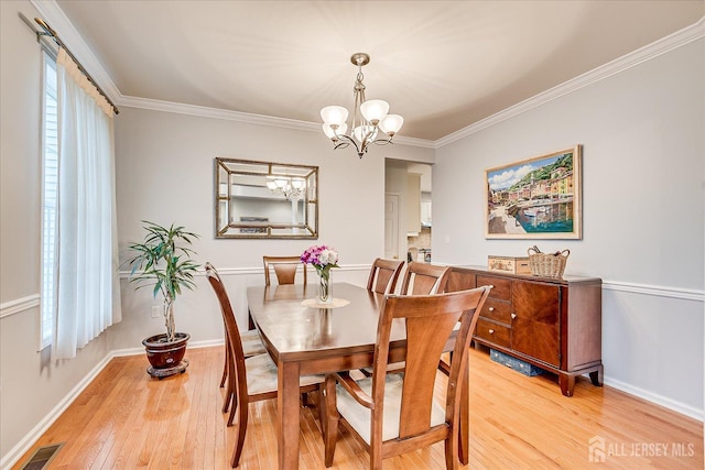 35 Fabiszewski Way, Parlin, NJ 08859 - dining area featuring light wood-style floors, a chandelier, ornamental molding, and baseboards