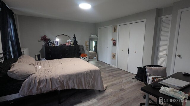 810-814 Leland Ave, Plainfield, NJ 07062 - bedroom with wood finished floors, multiple closets, arched walkways, and radiator