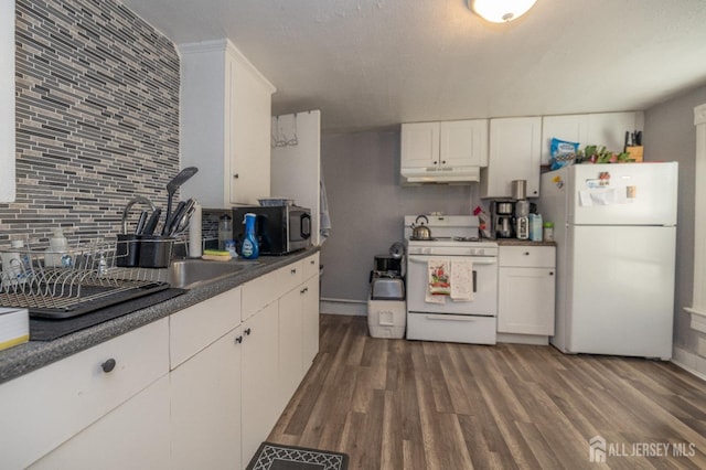 58 Smullen St, Sayreville, NJ 08872 - kitchen featuring white appliances, dark wood-type flooring, under cabinet range hood, decorative backsplash, and white cabinets