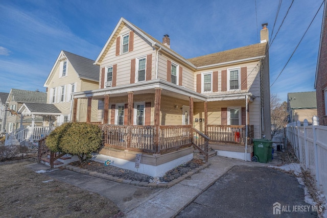 58 Smullen St, Sayreville, NJ 08872 - view of front facade with a porch, fence, and a chimney