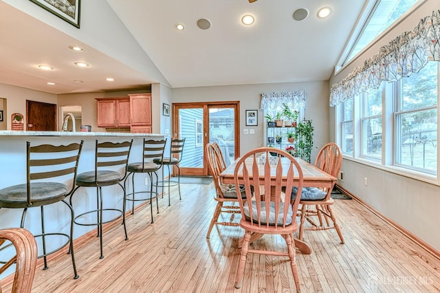 dining area featuring lofted ceiling, recessed lighting, and light wood finished floors