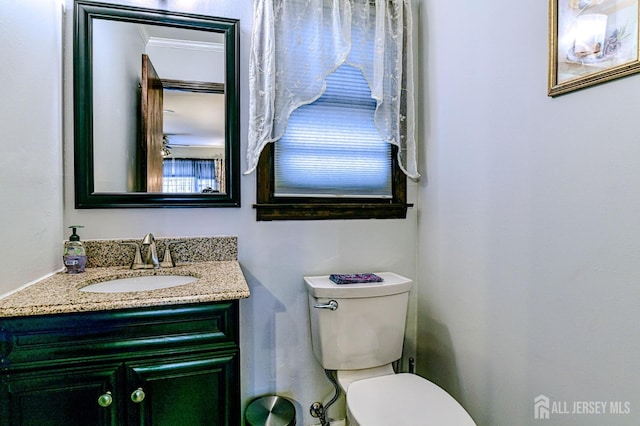 half bathroom featuring toilet and vanity