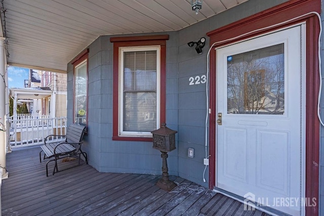 view of exterior entry with a porch