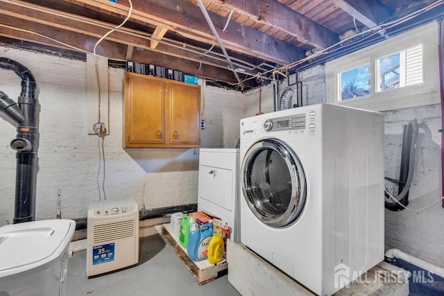 laundry area with cabinet space and separate washer and dryer