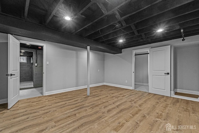 finished basement with light wood-style floors and baseboards