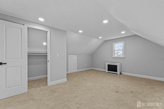 additional living space featuring radiator heating unit, recessed lighting, carpet flooring, baseboards, and vaulted ceiling