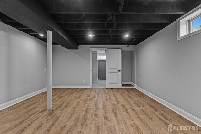 below grade area with wood finished floors and baseboards