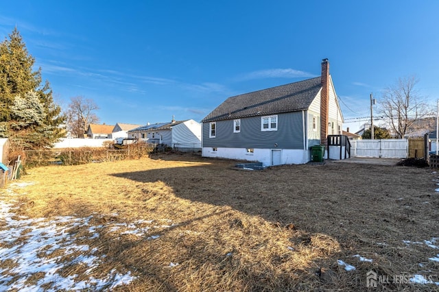 rear view of house with a lawn