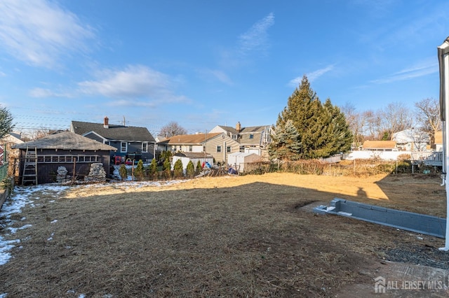 view of yard featuring fence and a residential view