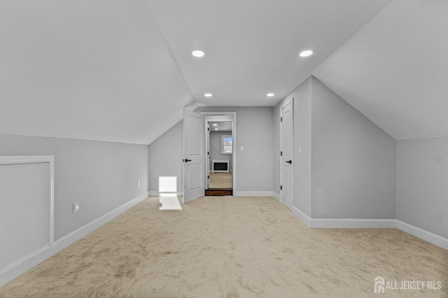 additional living space featuring recessed lighting, lofted ceiling, baseboards, and carpet floors