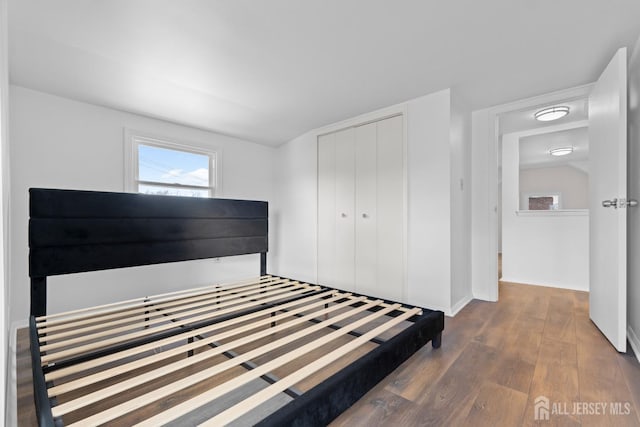 unfurnished bedroom with a closet and wood finished floors