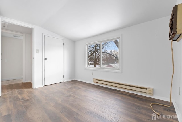 interior space featuring a baseboard radiator, lofted ceiling, visible vents, baseboards, and hardwood / wood-style flooring