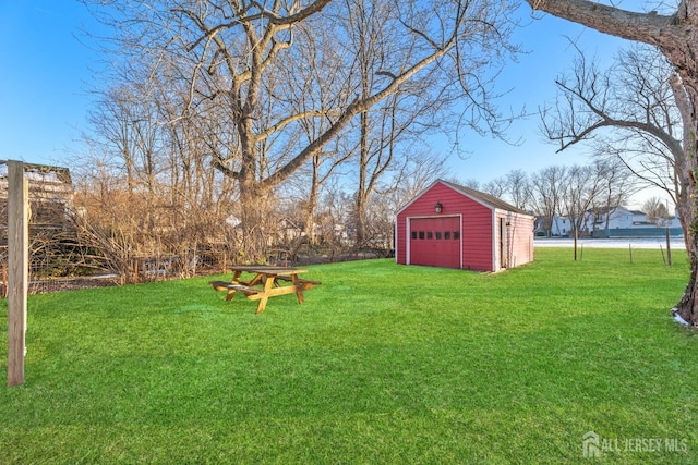 view of yard featuring an outbuilding and a detached garage