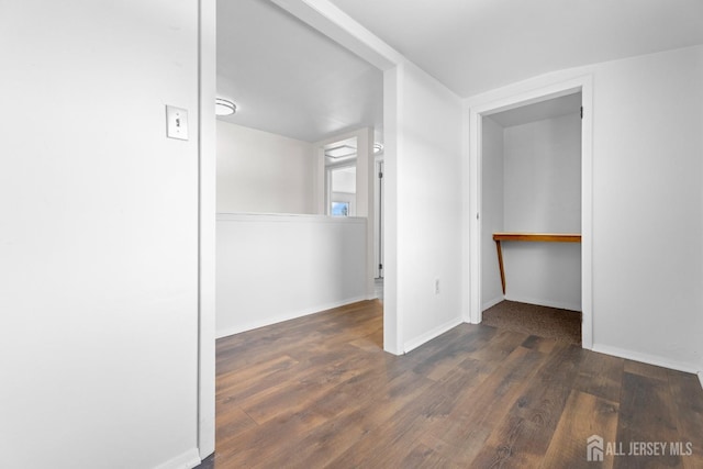 interior space featuring baseboards and wood finished floors