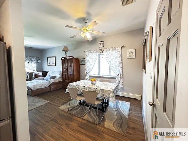 133 Pleasant Ave, Iselin, NJ 08830 - dining area with a baseboard heating unit, plenty of natural light, ceiling fan, and dark wood-style flooring
