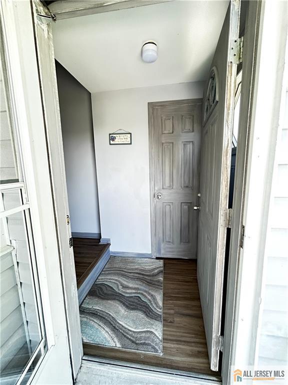 133 Pleasant Ave, Iselin, NJ 08830 - hallway with wood finished floors and baseboards