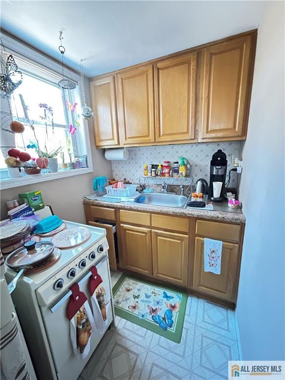 133 Pleasant Ave, Iselin, NJ 08830 - kitchen featuring a sink, white stove, light countertops, and backsplash