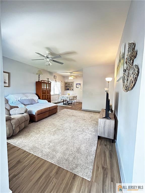 133 Pleasant Ave, Iselin, NJ 08830 - living area featuring ceiling fan, dark wood-style floors, and baseboards