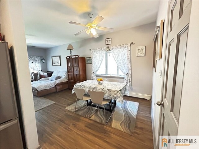 133 Pleasant Ave, Iselin, NJ 08830 - dining area with a baseboard radiator, healthy amount of natural light, a ceiling fan, and dark wood-style floors