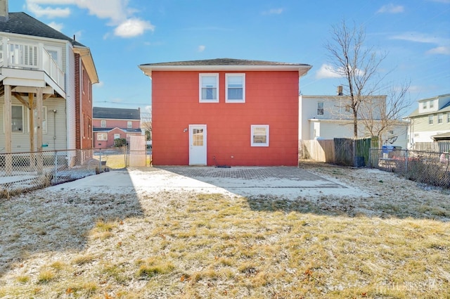 rear view of property featuring a fenced backyard and a residential view