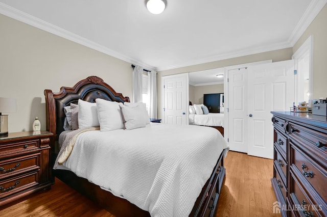 bedroom featuring ornamental molding and wood finished floors