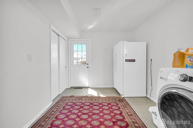 laundry area featuring washer / clothes dryer, baseboards, and laundry area