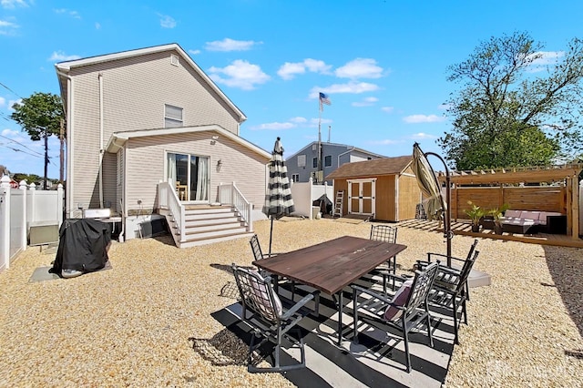 248 N 17th St N, Kenilworth, NJ 07033 - rear view of property with a storage unit, a fenced backyard, outdoor dining space, and a patio area