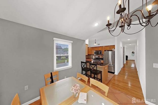 248 N 17th St N, Kenilworth, NJ 07033 - dining room with vaulted ceiling, a chandelier, light wood-type flooring, and washer / dryer