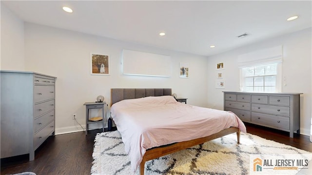 bedroom with dark wood-style floors, recessed lighting, and visible vents