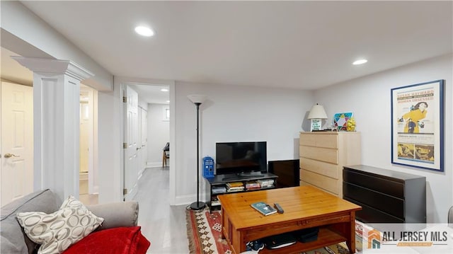 living room with recessed lighting, baseboards, and wood finished floors