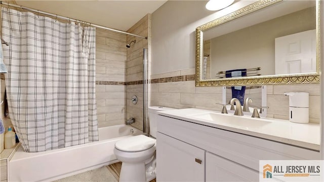 full bathroom featuring toilet, tile walls, shower / bath combo, and vanity