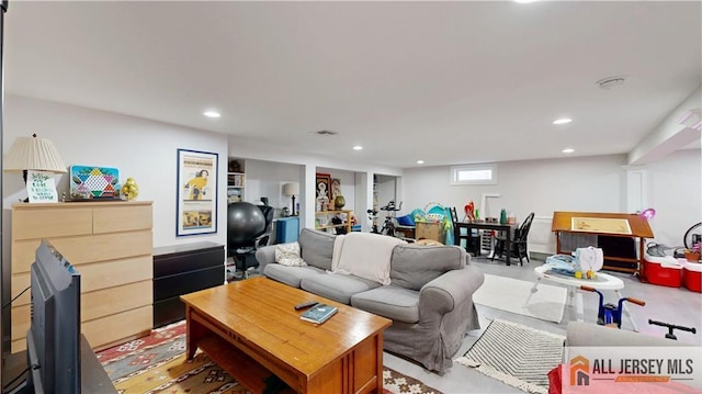 living room featuring recessed lighting and visible vents