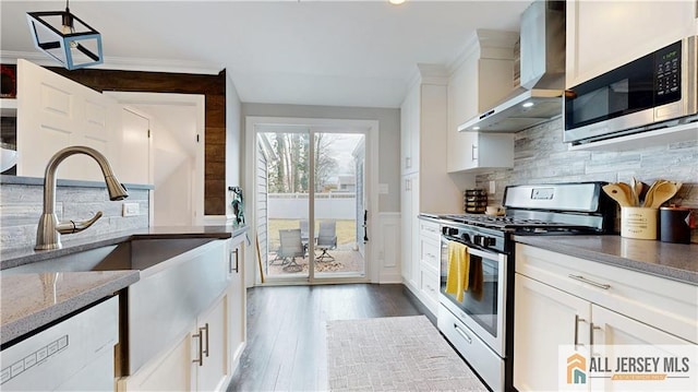 624 Lyman Ave, Woodbridge Proper, NJ 07095 - kitchen with stainless steel appliances, wall chimney exhaust hood, white cabinets, light stone counters, and tasteful backsplash