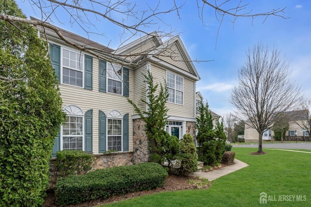 1 Kushnetki Rd, Parlin, NJ 08859 - view of side of property featuring stone siding and a lawn
