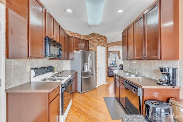1 Kushnetki Rd, Parlin, NJ 08859 - kitchen with black microwave, range with gas cooktop, dishwashing machine, stainless steel fridge, and decorative backsplash