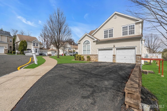 1 Kushnetki Rd, Parlin, NJ 08859 - view of front of property featuring driveway, an attached garage, stone siding, and a front lawn