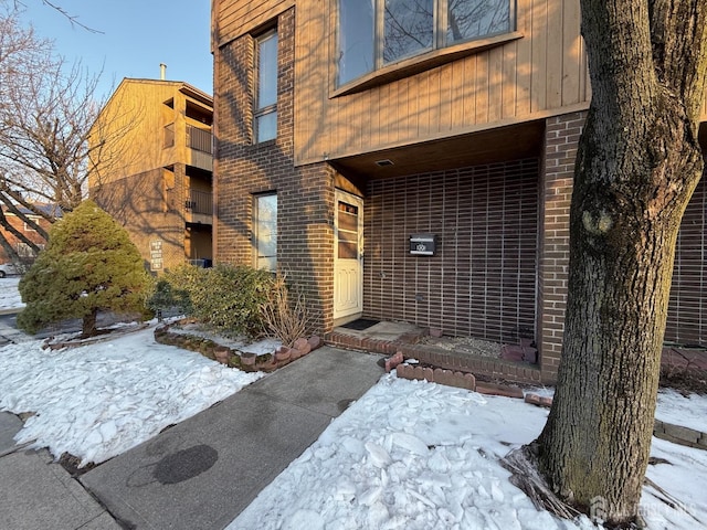 entrance to property with brick siding