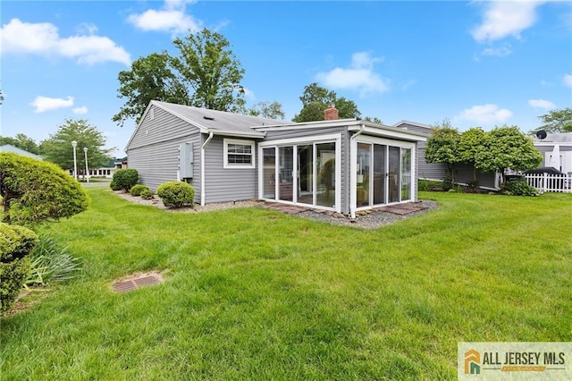 2 Belmar Rd Unit C, Monroe, NJ 08831 - rear view of property with a chimney, a sunroom, and a lawn