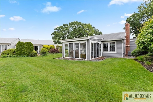 2 Belmar Rd Unit C, Monroe, NJ 08831 - rear view of property featuring a sunroom, a chimney, a yard, and central air condition unit