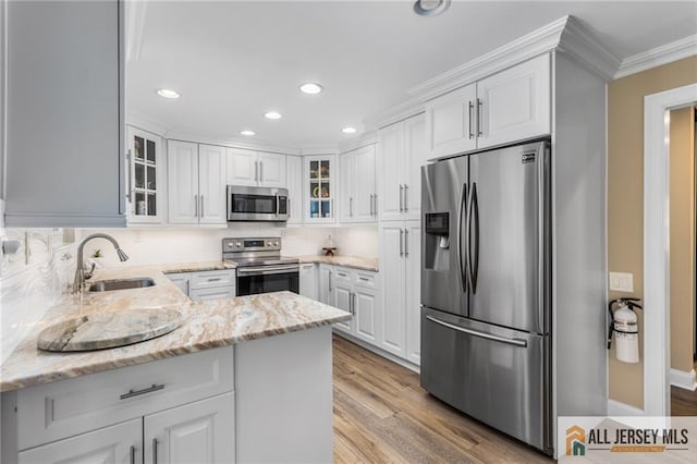2 Belmar Rd Unit C, Monroe, NJ 08831 - kitchen with stainless steel appliances, ornamental molding, white cabinetry, recessed lighting, and backsplash