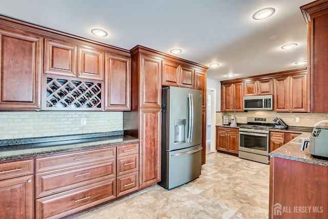 108 Morris Ave, Edison, NJ 08837 - kitchen with appliances with stainless steel finishes, tasteful backsplash, brown cabinets, and dark stone counters