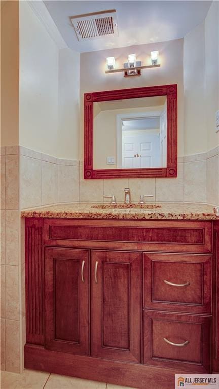 1141 Schmidt Ln, North Brunswick, NJ 08902 - bathroom with tile walls, vanity, tile patterned flooring, and wainscoting