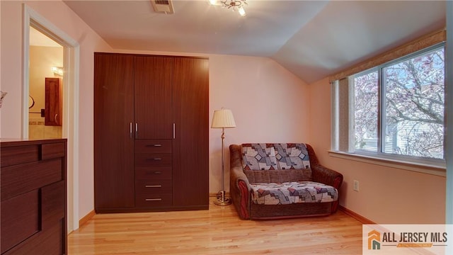 1141 Schmidt Ln, North Brunswick, NJ 08902 - sitting room featuring lofted ceiling, light wood-style floors, and baseboards