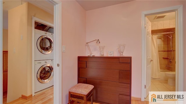 1141 Schmidt Ln, North Brunswick, NJ 08902 - washroom with stacked washer / drying machine and light tile patterned floors