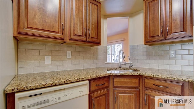 1141 Schmidt Ln, North Brunswick, NJ 08902 - kitchen with dishwasher, a sink, light stone counters, and brown cabinetry