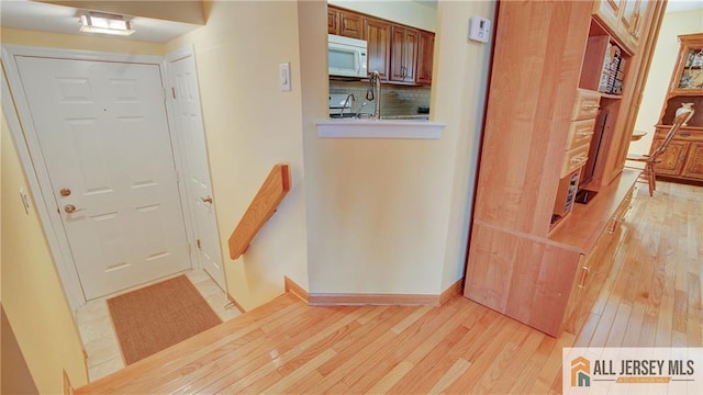 1141 Schmidt Ln, North Brunswick, NJ 08902 - entryway with light wood finished floors and baseboards