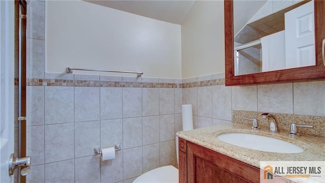 1141 Schmidt Ln, North Brunswick, NJ 08902 - bathroom featuring toilet, vanity, tile walls, and a shower with door